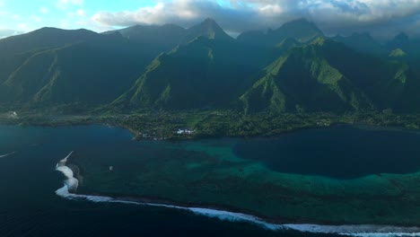 last light sunset towering mountain peaks surf reef break channel teahupoo wave tahiti french polynesia aerial drone view incredible stunning island landscape moorea bora bora papeete circle right