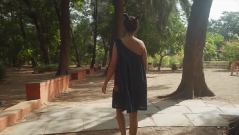 back-view-of-a-woman-stands-with-a-concerned-expression,-her-gaze-fixed-on-the-environmental-challenges-that-surround-her