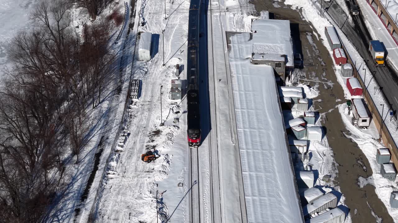 Train travels through snowy Springfield, capturing winter's calm and motion