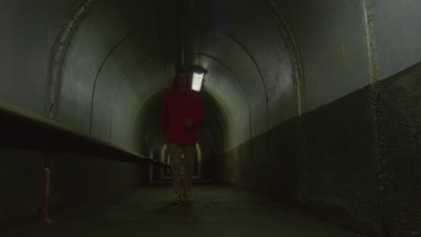 parkourist running in tunnel and doing flip
