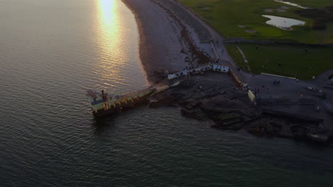 aerial angled orbit of people swimming below blackrock diving board in salthill galway ireland