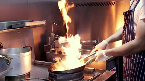 stir fry cooking with flames slow motion