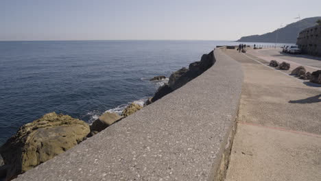 majestic rocky coastline and concrete walkway in city of san sebastian