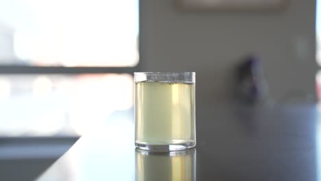 Pouring-Apple-Juice-In-Clear-Glass-Modern-Kitchen-Counter