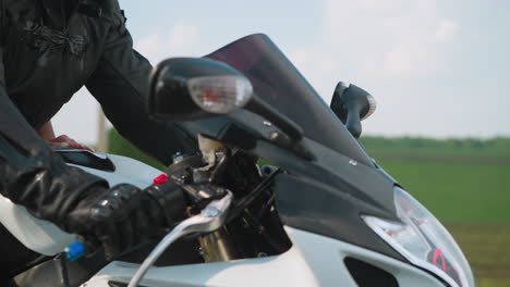 Woman-hugs-beloved-boyfriend-motorcyclist-riding-past-field