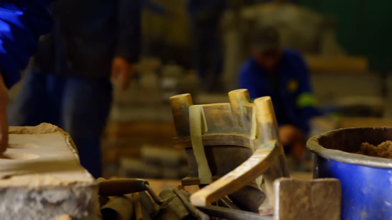 Close-up of worker putting soil in bucket with shovel 4k