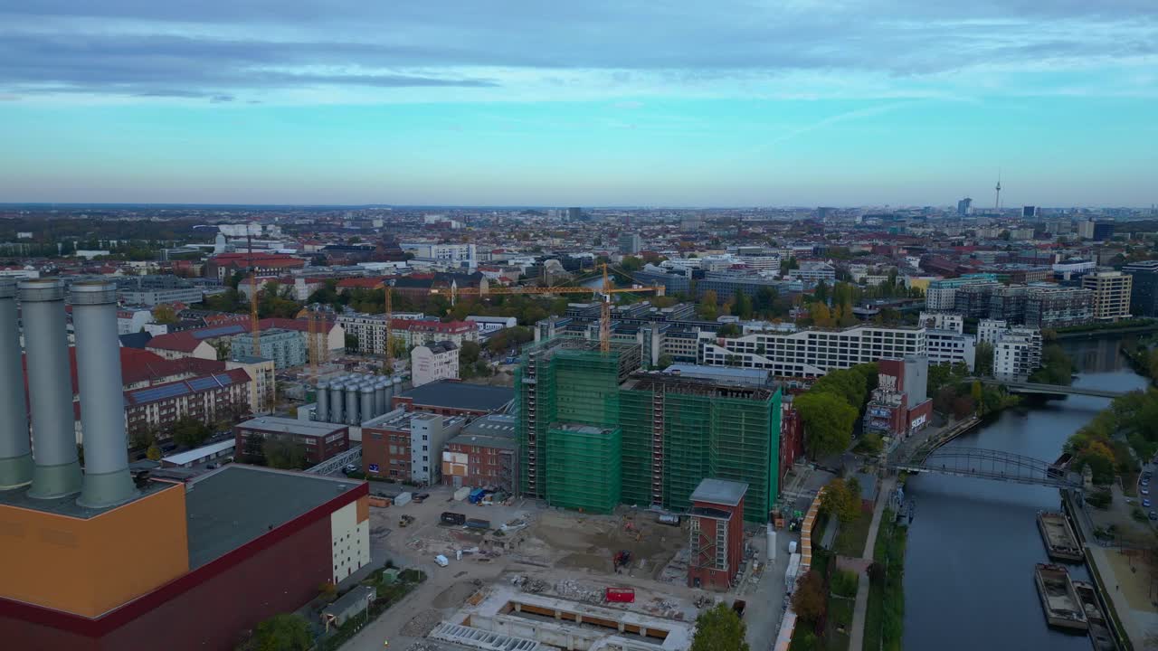 converted cogeneration Power plant , industrial buildings, and a large urban construction site. Breathtaking aerial view flight fly reverse drone