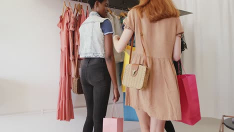 young adult female friends in a clothes shop