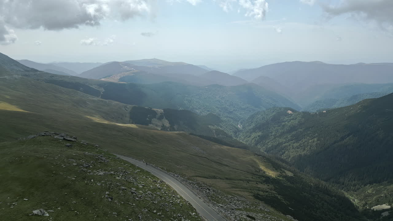 A breathtaking panorama of a mountainous landscape with lush green valleys and dense forests