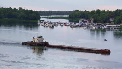 tug boat pushing barge at mooring view drone shot. empty cargo ship floating.