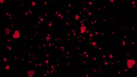 corazones rojos flotando sobre un fondo negro