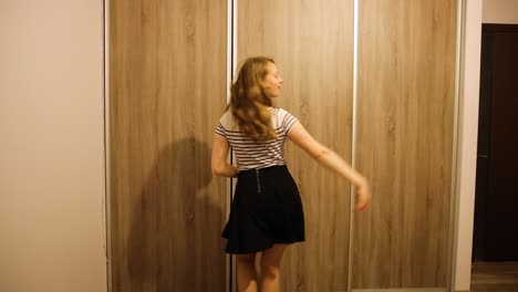 girl practices dancing in her room by her own