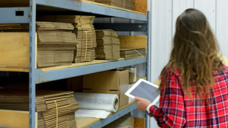 side view of caucasian female worker checking stocks in warehouse 4k