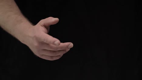 male hands on a black background