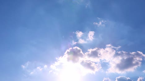 timelapse: sun beams shining through moving dramatic white clouds