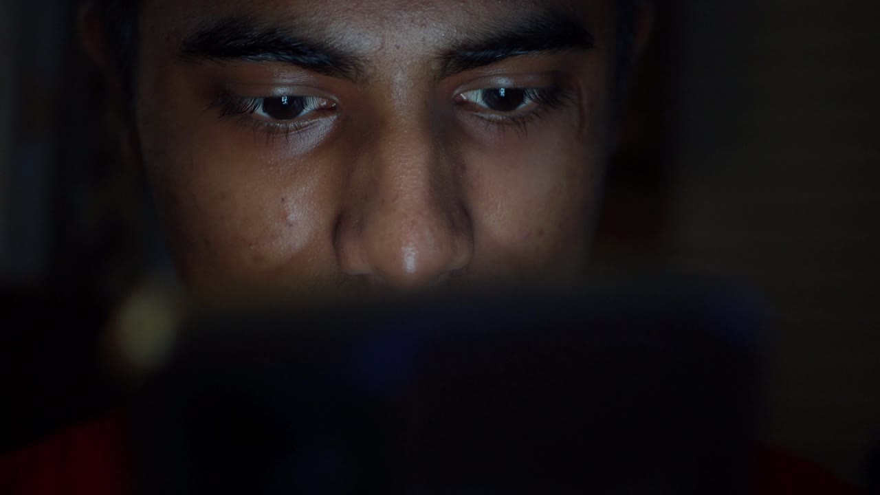 Young person using smartphone at night