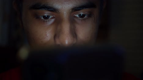 young person using smartphone at night