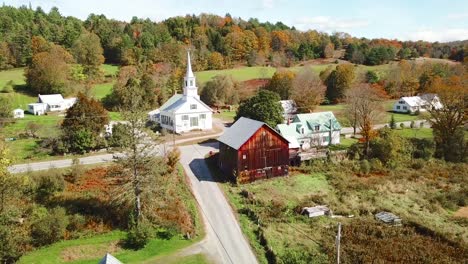 an aerial over a charming small village scene in vermont with church road and farm 2