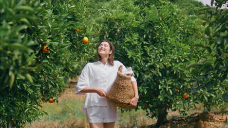 happy lady strolling orange sunlight garden. young woman walking lush greenery