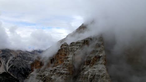 aerial views of italian dolomites peaks in a foggy and cloudy day