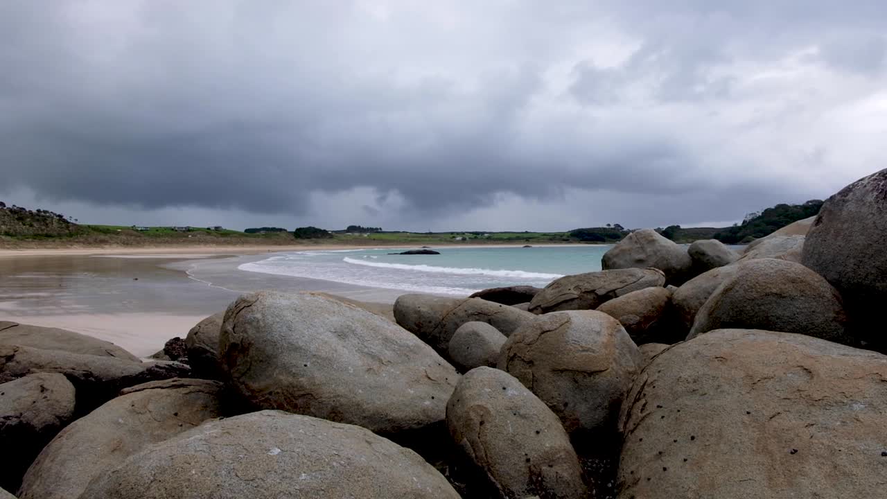 Stunning rounded boulders on the beach at unique landscape of Matai Bay on Karikari Peninsula in North Island, New Zealand Aotearoa. Moody cloudy day on the beach