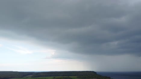 aerial dolly in shot dark clouds covering lake huron in bruce peninsula
