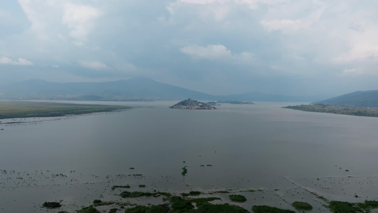 DRONE: DOLLY IN SHOT OF JANITZIO ISLAND AT SUNSET FROM PATZCUARO LAKE
