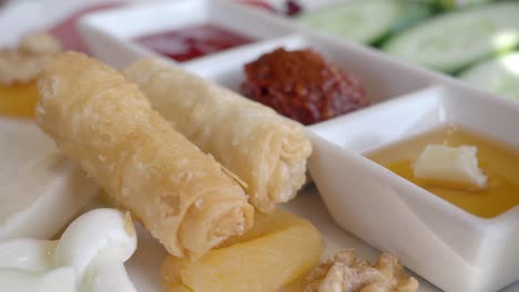 turkish breakfast platter with phyllo rolls and dips