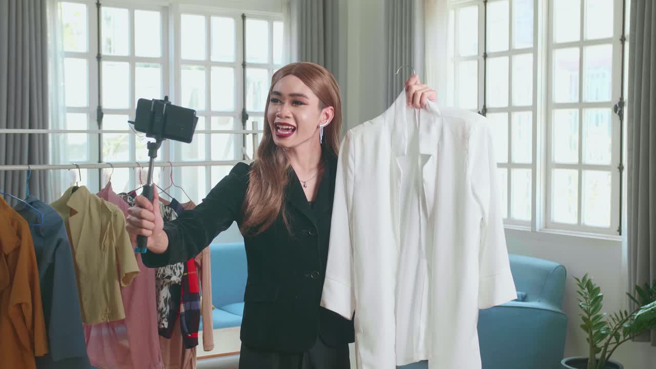 Young Transgender Woman Fashion Blogger Selling Clothes Online By Live Streaming On Mobile Phone, Selfie