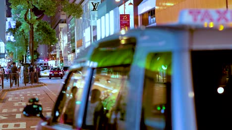 taxi moves through busy hong kong street