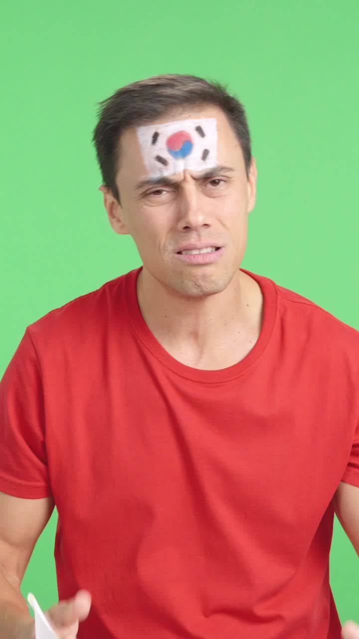 Man cheering for South Korea during a match that is lost