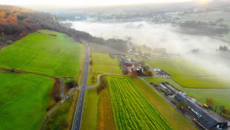 flight over valley green valley with morning mist and a small rural village