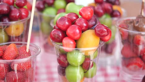 assortment of fresh fruits in transparent cups