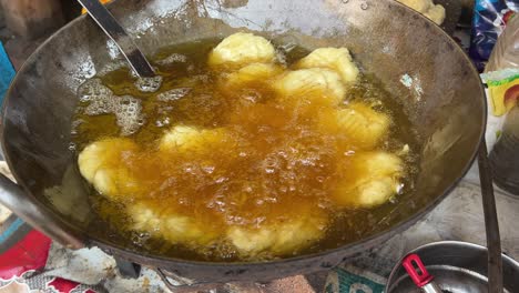 traditional thekua being fried in hot oil in local dhaba in bihari style