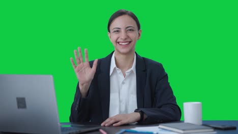 Happy-Indian-business-woman-waving-Hi-to-the-camera-Green-screen