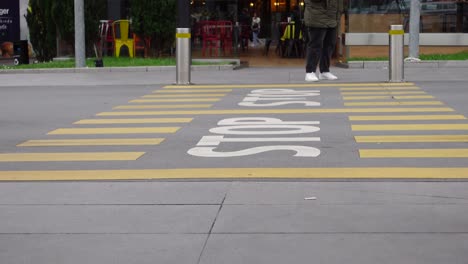 person walking on a crosswalk with a stop sign