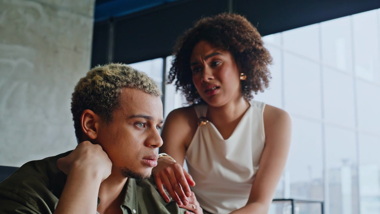 Worried woman comforting stressed man. Upset couple relationship problems
