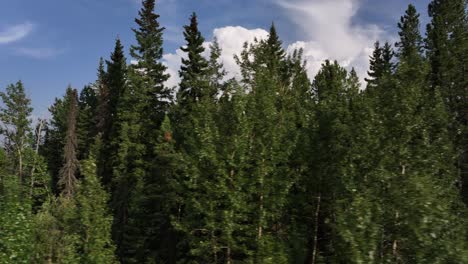 sliding right drone reveals a starting thunderstorm over the foothills of alberta, canada