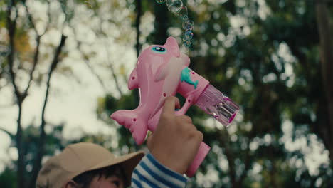pink dolphin bubble gun in a park