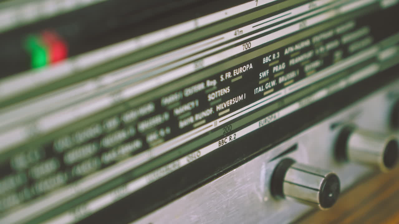 Close-up of radiogram radio display showing international city frequency scale. Suitable for broadcasting history, analog communication and retro electronics visuals