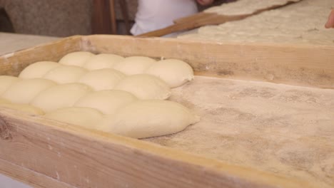 closeup of dough in a wooden tray