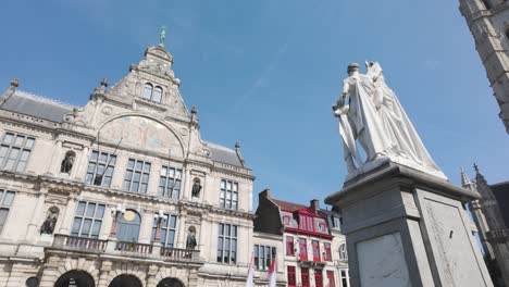 a grand architectural building with a statue, capturing ghent’s charm on a sunny day