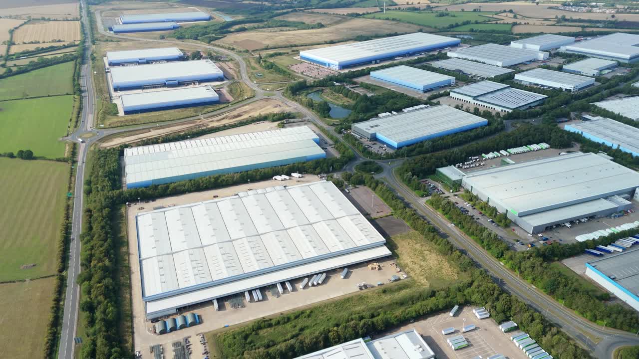 Drone flight over Magna Park Lutterworth England UK showing massive industrial warehouses retail park factories and distribution centres at sunset