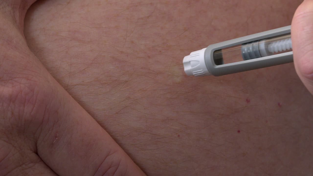 Clear semaglutide medication is injected into subcutaneous belly fat