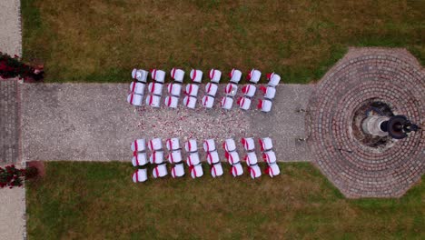 aerial shot overhead an exterior wedding ceremony with petals in the aisle