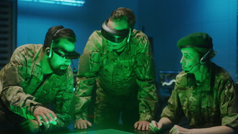soldiers discussing military strategy. medium shot of vr headset wearing soldiers discussing military strategy in a futuristic secret military base