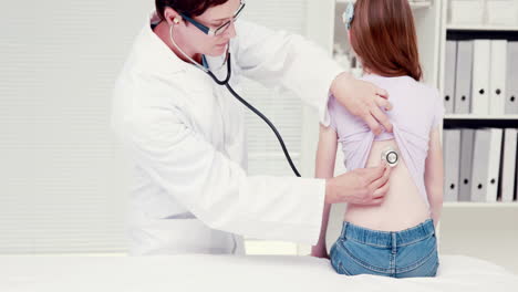 Doctor-examining-her-patient-with-stethoscope