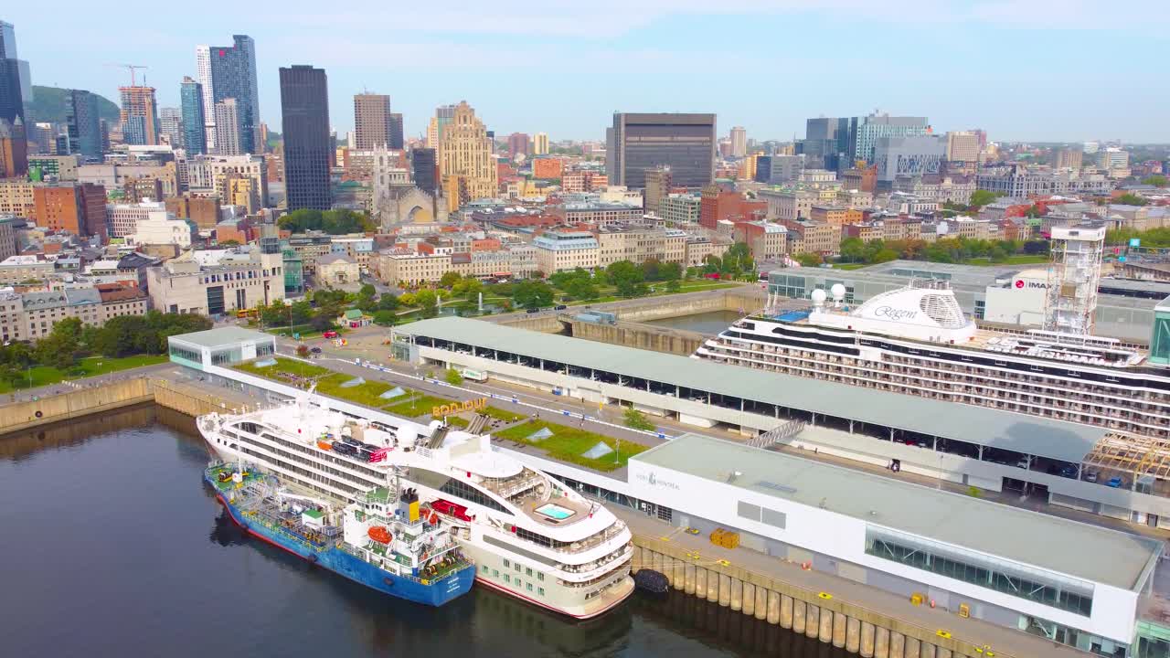 Aerial over the port of Montréal with two docked cruise ships and the city skyline