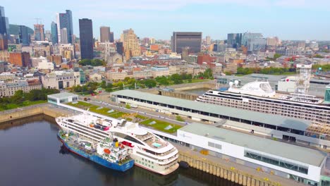 aerial over the port of montréal with two docked cruise ships and the city skyline