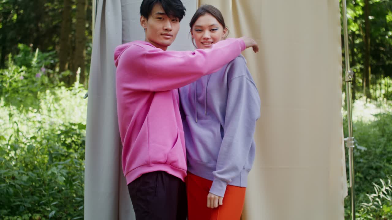 Couple in Hoodies in Forest